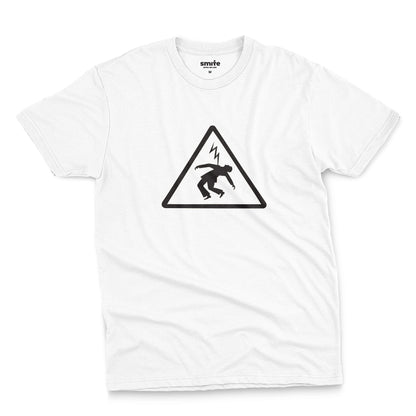 A white t-shirt with an old Spanish sign on it, warning of the danger of electrocution.