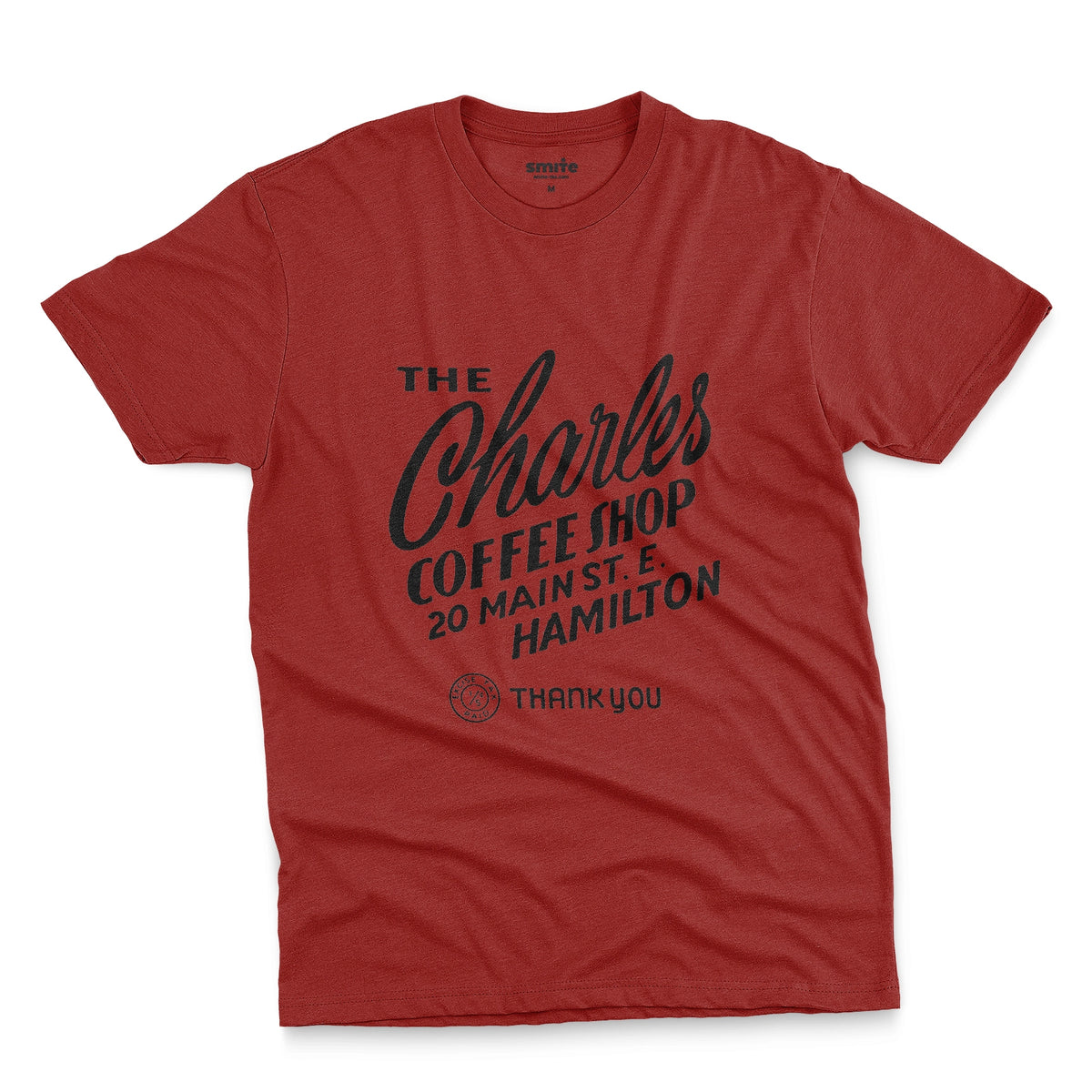 A red t-shirt with a retro typographic logo for The Charles Coffee Shop in Hamilton.