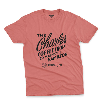 A coral pink t-shirt with a retro typographic logo for The Charles Coffee Shop in Hamilton.