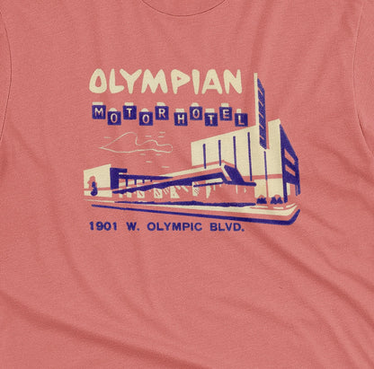 A coral pink t-shirt with a vintage advertisement for the Olympian Motor Hotel.