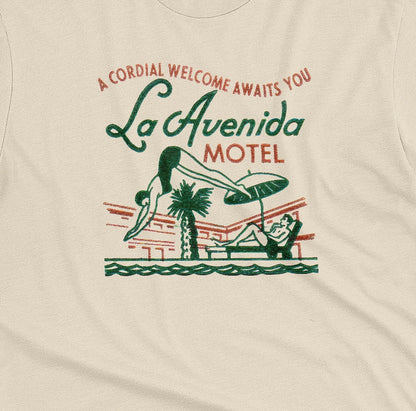 A beige t-shirt featuring a retro advertisement for La Avenida Motel from the 1960s.