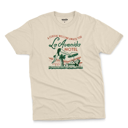 A beige t-shirt featuring a retro advertisement for La Avenida Motel from the 1960s.