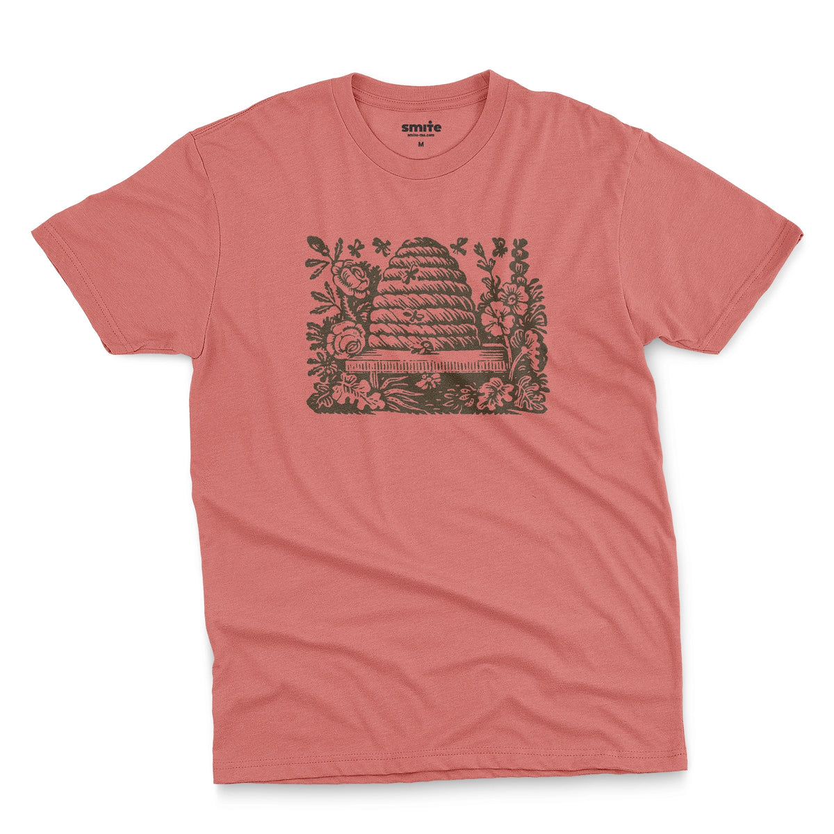 A coral pink t-shirt featuring a retro engraved graphic print of a beehive surrounded by flowers.