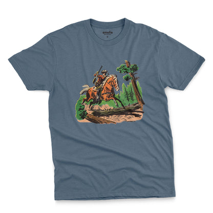 A blue t-shirt featuring a 1960s vintage graphic print of a cowboy riding a horse through a forest.