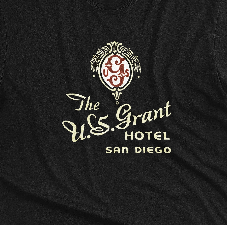 A black t-shirt with a vintage logo for the U.S. Grant Hotel in San Diego.