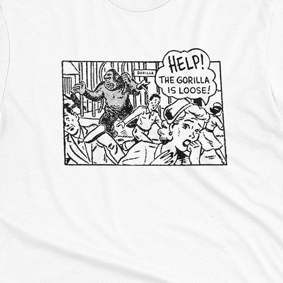 A white t-shirt featuring a retro comic-style graphic depicting a gorilla and the text 'HELP! THE GORILLA IS LOOSE!'.