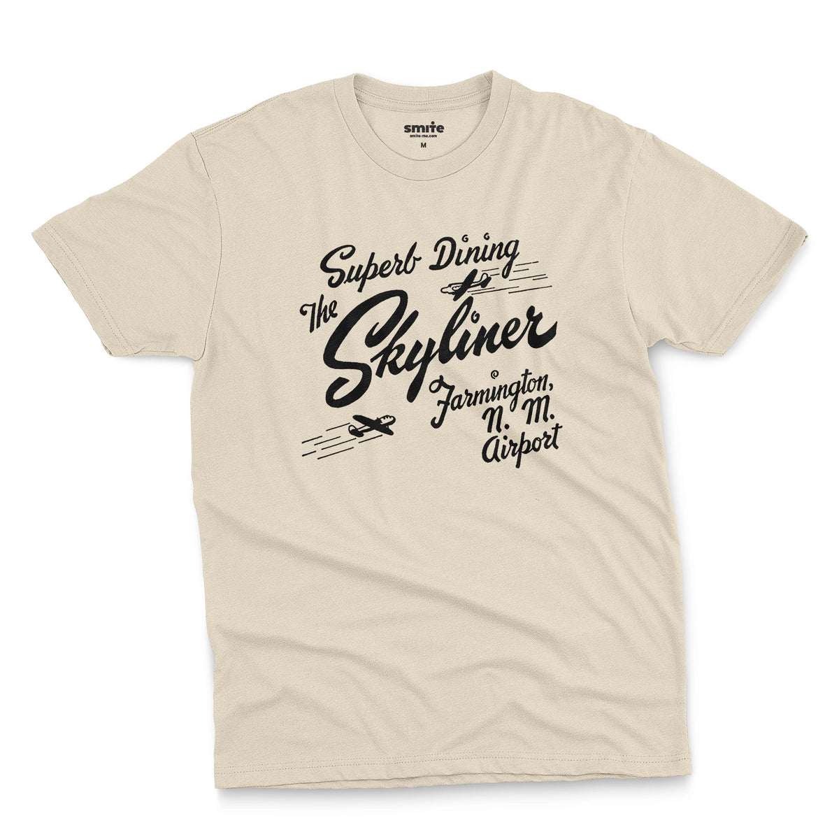 A beige t-shirt with a retro advertisement for The Skyliner restaurant at the airport in Farmington, New Mexico.