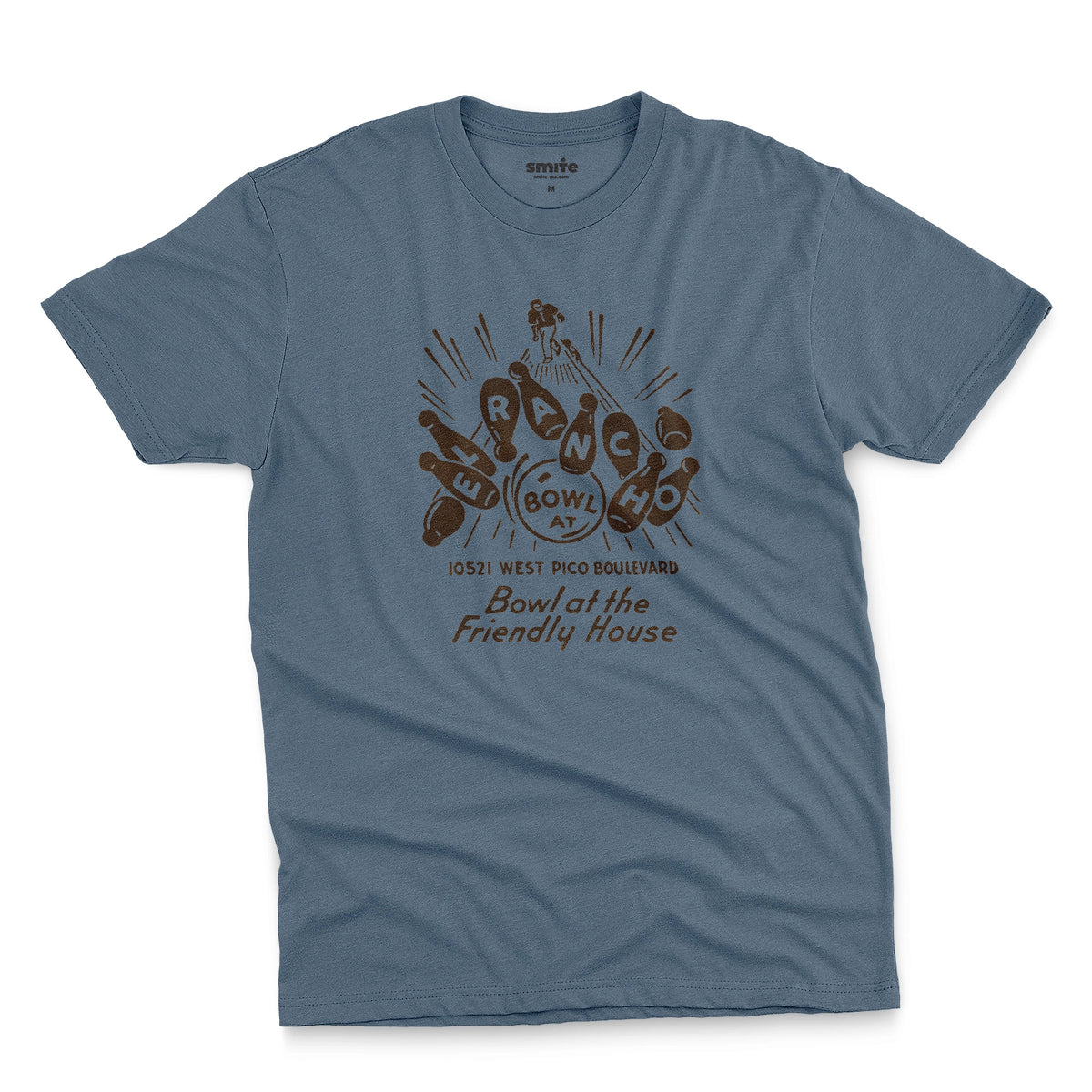 A blue t-shirt with a retro 1960s graphic advertisement for El Rancho bowling alley features bowling pins, bowling balls, and the text 'Bowl at the Friendly House' along with an illustration of a bowler.