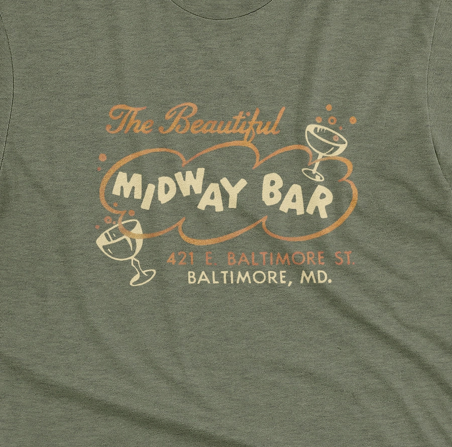 A green t-shirt with a retro advertisement for the Midway Bar in Baltimore.
