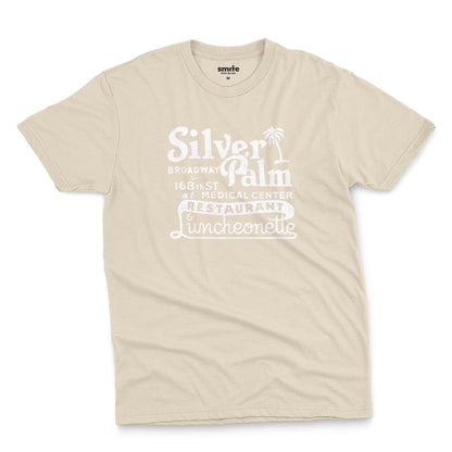 A beige t-shirt with a retro advertisement for Silver Palm Restaurant in New York.