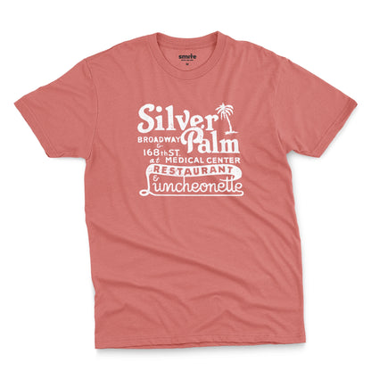 A coral pink t-shirt with a retro advertisement for Silver Palm Restaurant in New York.