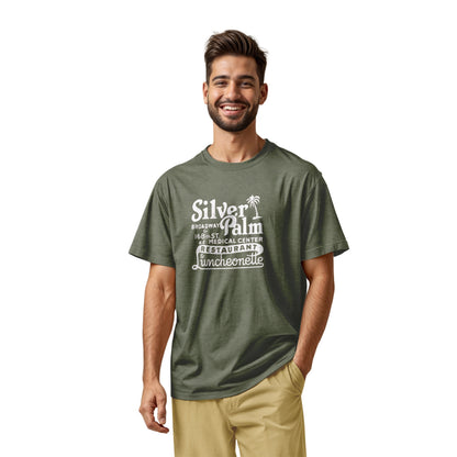 A green t-shirt with a retro advertisement for Silver Palm Restaurant in New York.