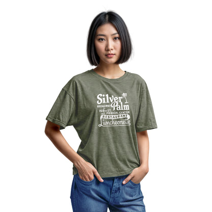 A green t-shirt with a retro advertisement for Silver Palm Restaurant in New York.