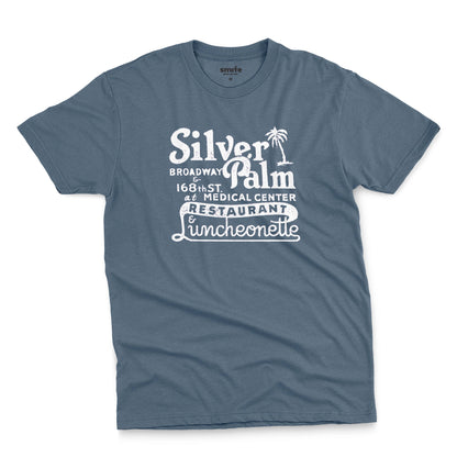A blue t-shirt with a retro advertisement for Silver Palm Restaurant in New York.