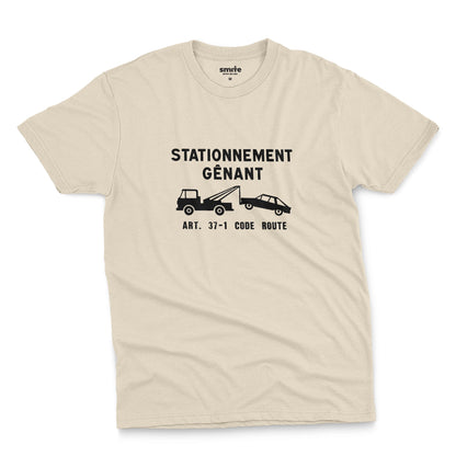 A beige t-shirt with a graphic print of a French street sign that says "nuisance parking" in French and a picture of a car being towed away.