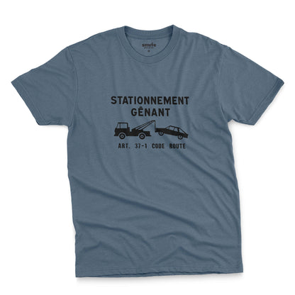 A blue t-shirt with a graphic print of a French street sign that says "nuisance parking" in French and a picture of a car being towed away.