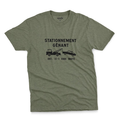 A green t-shirt with a graphic print of a French street sign that says "nuisance parking" in French and a picture of a car being towed away.