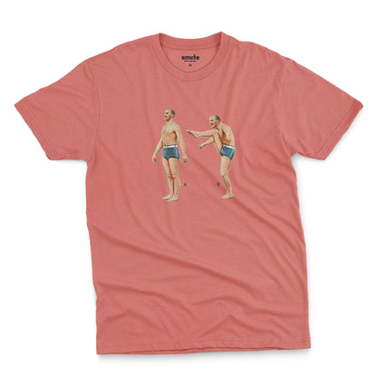 A coral pink t-shirt featuring a 1960s vintage graphic of an exercising man in blue swim trunks, labeled A and B.
