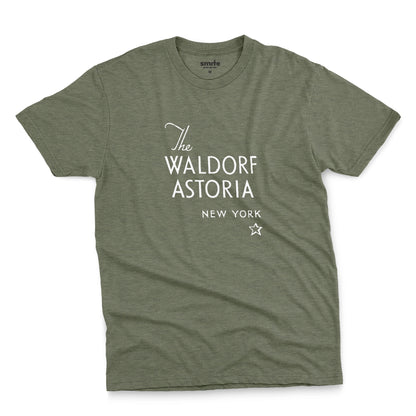 A green t-shirt with a retro logo for The Waldorf Astoria hotel in New York.
