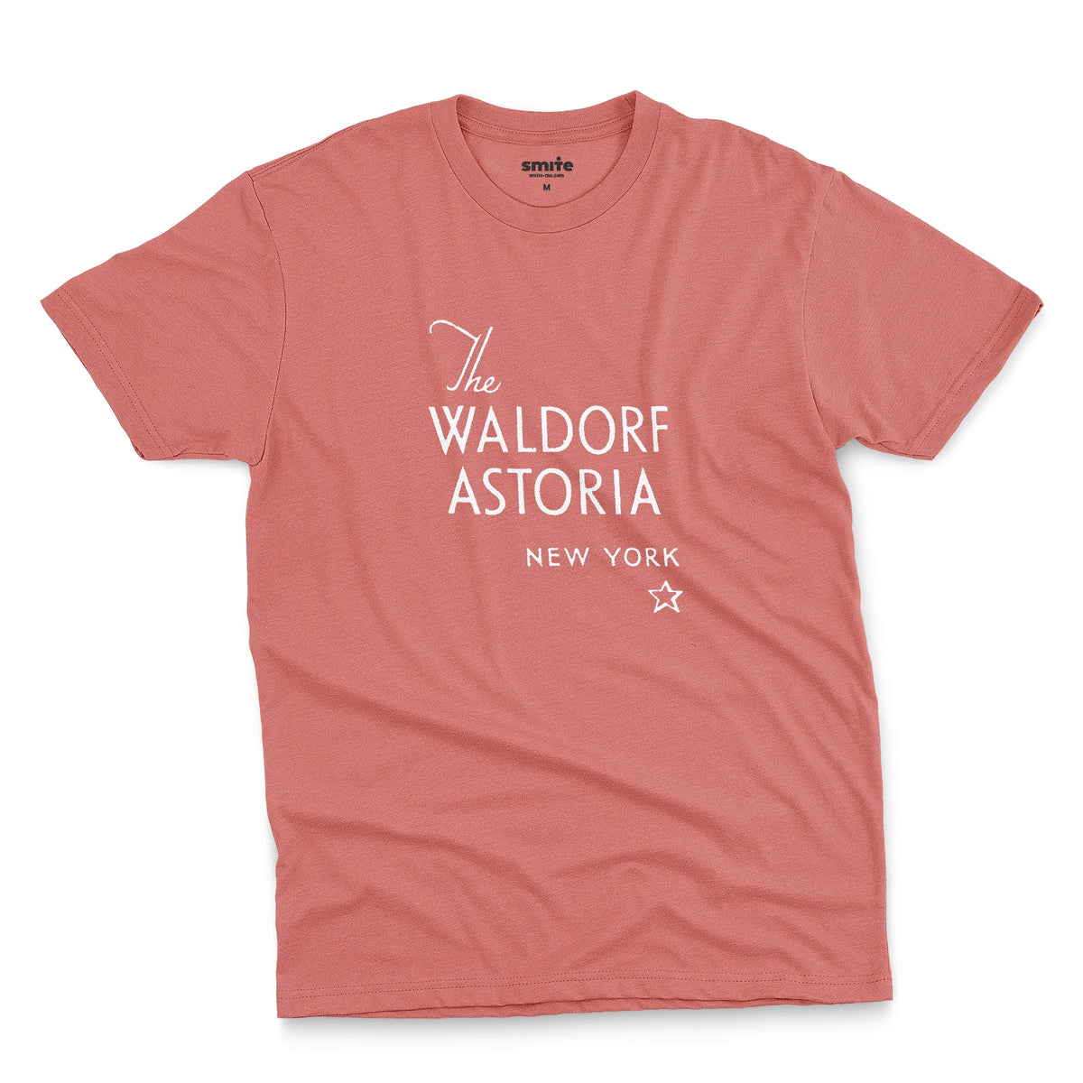 A coral pink t-shirt with a retro logo for The Waldorf Astoria hotel in New York.