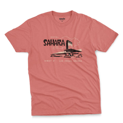 A coral pink t-shirt with a vintage graphic advertising the 'Hotel Sahara' in Las Vegas, Nevada.