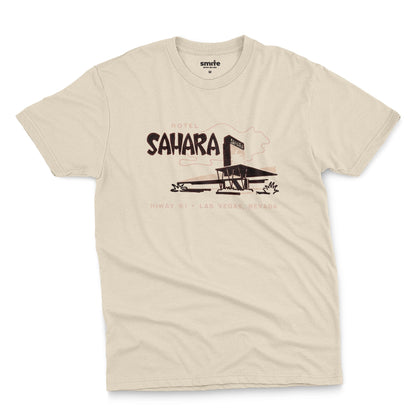 A beige t-shirt with a vintage graphic advertising the 'Hotel Sahara' in Las Vegas, Nevada.