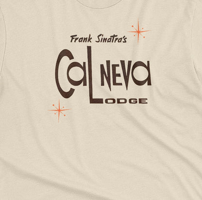 A beige t-shirt featuring a retro graphic print of 'Frank Sinatra's Cal Neva Lodge', the legendary hotel and casino.