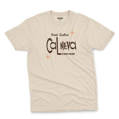 A beige t-shirt featuring a retro graphic print of 'Frank Sinatra's Cal Neva Lodge', the legendary hotel and casino.
