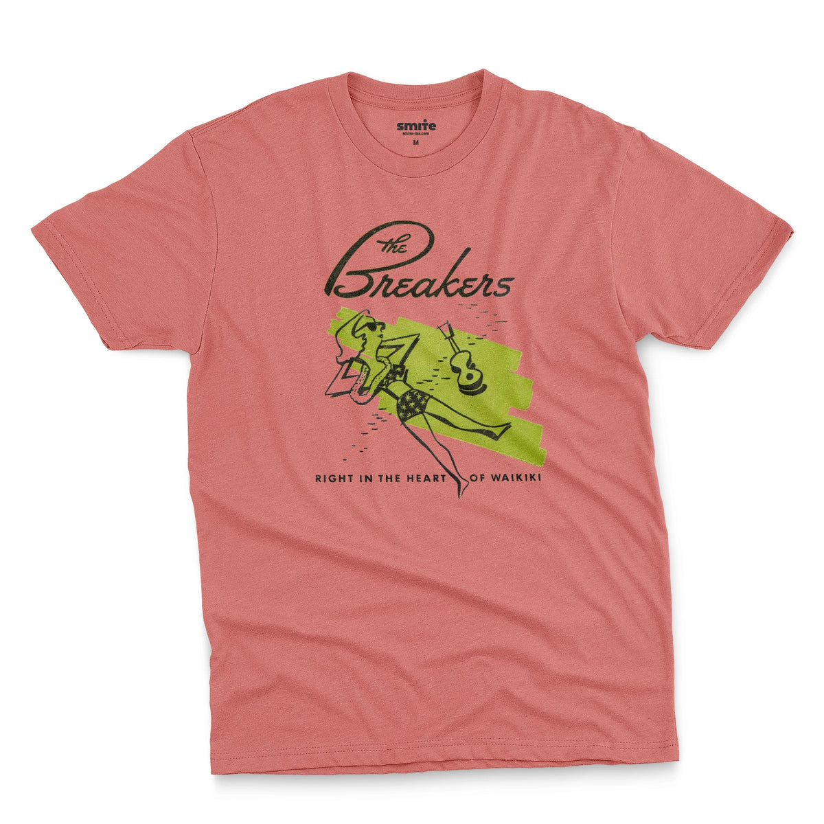 A coral pink t-shirt featuring a retro illustration of a woman sunbathing, advertising The Breakers, a Hawaiian hotel.