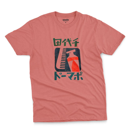 A coral pink t-shirt with a retro Japanese graphic of a comb and toothpaste and Japanese text.