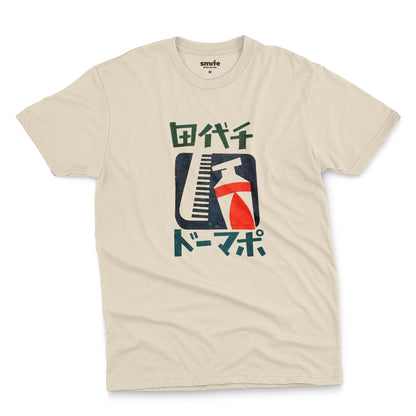 A beige t-shirt with a retro Japanese graphic of a comb and toothpaste and Japanese text.
