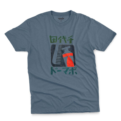 A blue t-shirt with a retro Japanese graphic of a comb and toothpaste and Japanese text.