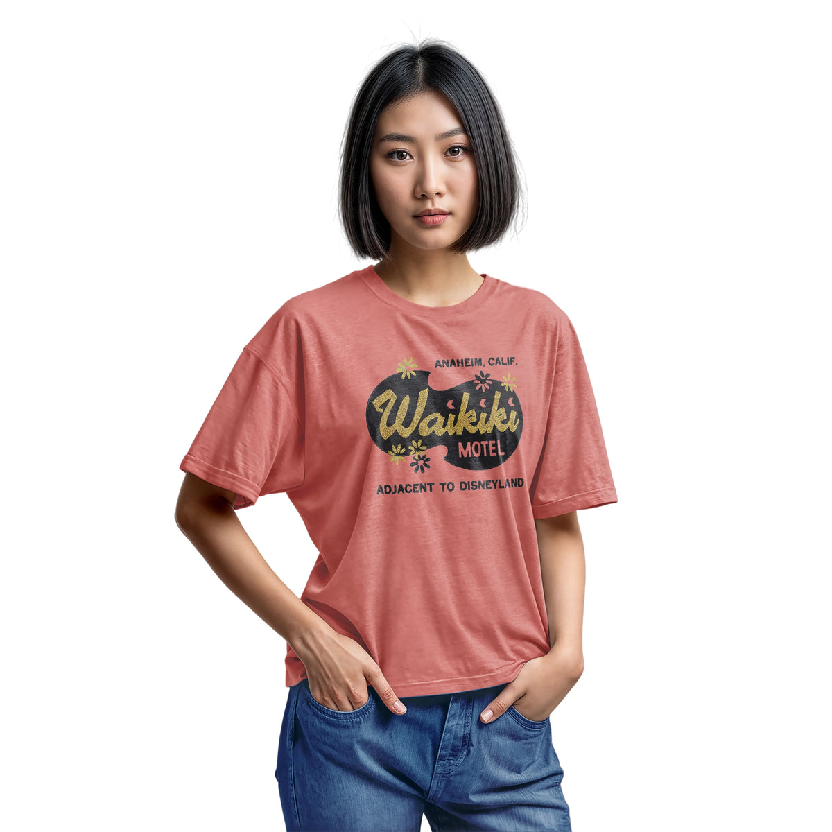 A coral pink t-shirt with a retro advertisement for the 'Waikiki Motel' in Anaheim, California.