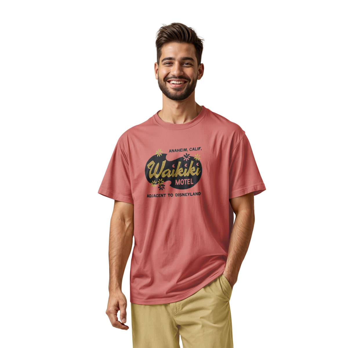 A coral pink t-shirt with a retro advertisement for the 'Waikiki Motel' in Anaheim, California.