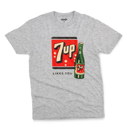 A gray marle t-shirt featuring a retro advertisement for 7up with the text '7up LIKES YOU'.