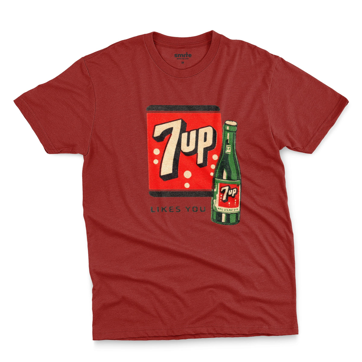 A red t-shirt featuring a retro advertisement for 7up with the text '7up LIKES YOU'.