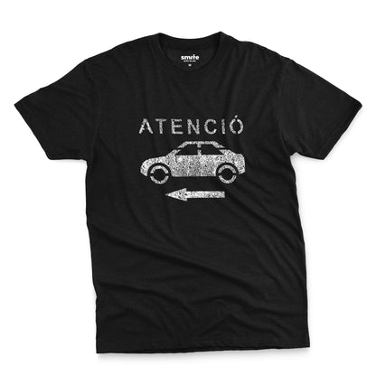 A black t-shirt with a retro white stencil graphic of a car and the Spanish word 'ATENCIÓ'.