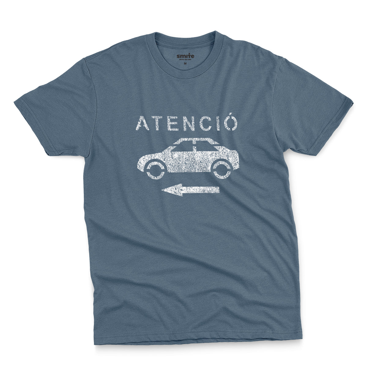 A blue t-shirt with a retro white stencil graphic of a car and the Spanish word 'ATENCIÓ'.