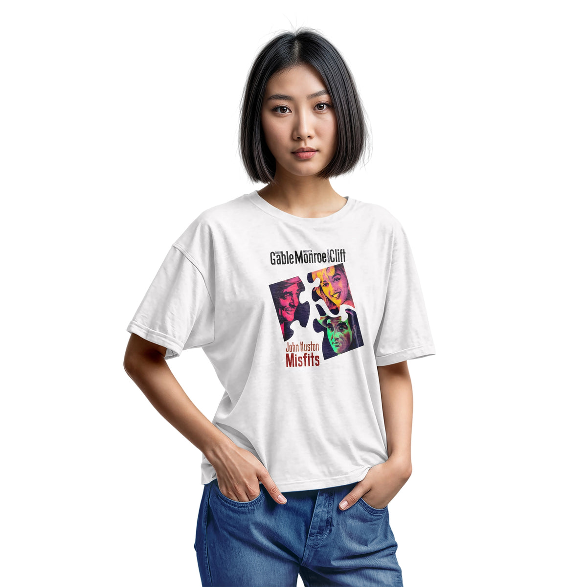A white t-shirt featuring a colorful graphic advertisement for the movie Misfits starring Clark Gable, Marilyn Monroe, and Montgomery Clift.