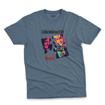 A blue t-shirt featuring a colorful graphic advertisement for the movie The Misfits starring Clark Gable, Marilyn Monroe, and Montgomery Clift.