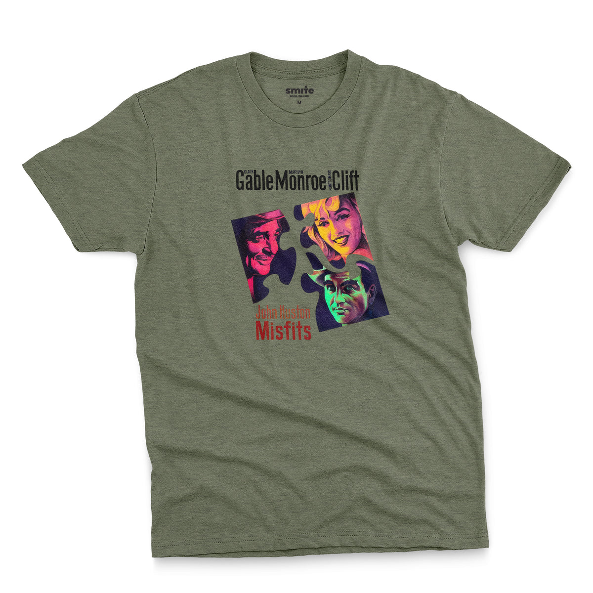 A green t-shirt featuring a colorful graphic advertisement for the movie The Misfits starring Clark Gable, Marilyn Monroe, and Montgomery Clift.