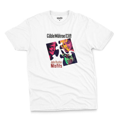 A white t-shirt featuring a colorful graphic advertisement for the movie The Misfits starring Clark Gable, Marilyn Monroe, and Montgomery Clift.