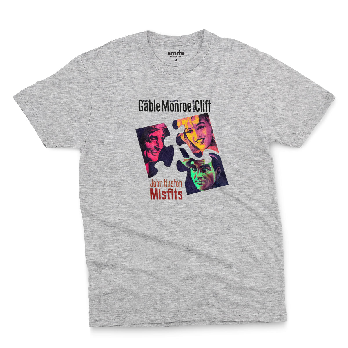 A gray marle t-shirt featuring a colorful graphic advertisement for the movie The Misfits starring Clark Gable, Marilyn Monroe, and Montgomery Clift.