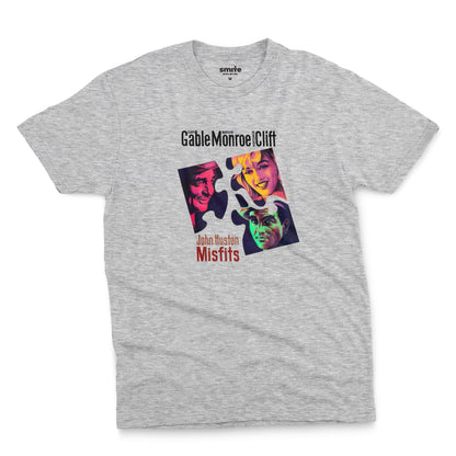 A gray marle t-shirt featuring a colorful graphic advertisement for the movie The Misfits starring Clark Gable, Marilyn Monroe, and Montgomery Clift.