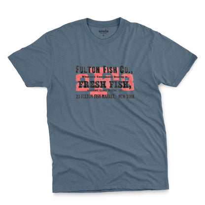 A blue t-shirt with an advertisement for the 'FULTON FISH CO' in New York from the 1970s.