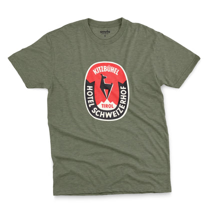 A green t-shirt featuring a retro baggage label for the Hotel Schweizerhof in the Austrian Alps.