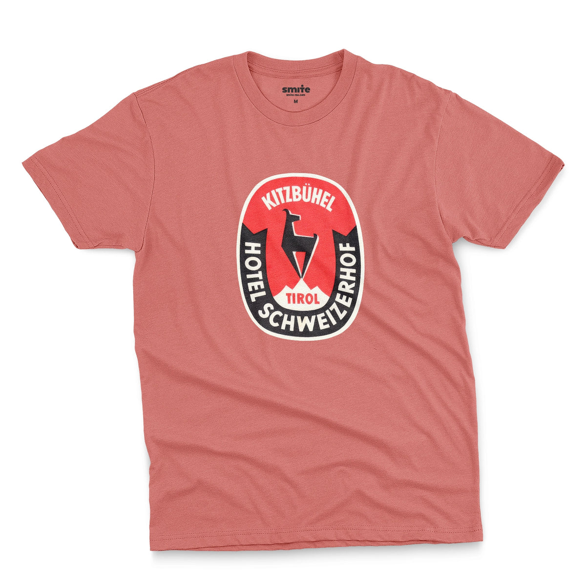 A coral pink t-shirt featuring a retro baggage label for the Hotel Schweizerhof in the Austrian Alps.