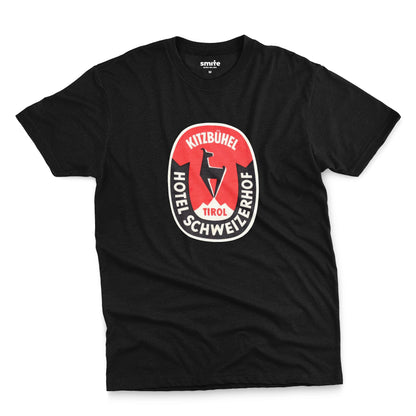 A black t-shirt featuring a retro baggage label for the Hotel Schweizerhof in the Austrian Alps.