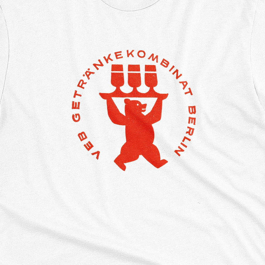 A white t-shirt featuring a vintage graphic print of a bear holding three beer glasses, taken from a beer coaster in Berlin.